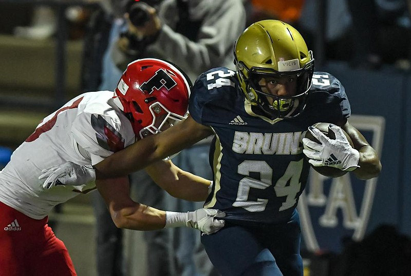 Pulaski Academy running back Caleb Nichols (24) runs away from Farmington defensive back Decory Thomas during the Bruins’ 51-21 victory over the Cardinals on Friday at Joe B. Hatcher Stadium in Little Rock. More photos at arkansasonline.com/1121farmpa/.
(Special to the Democrat-Gazette/Jimmy Jones)