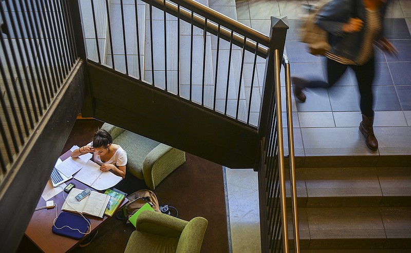 Hendrix College sophomore Hannah Sigda, lower left, completely overtakes a table inside her school's Student Life and Technology Center for a study session in cellular biology, pre-calculus and Spanish on Oct. 9, 2013 on campus in Conway. (Democrat-Gazette file photo)