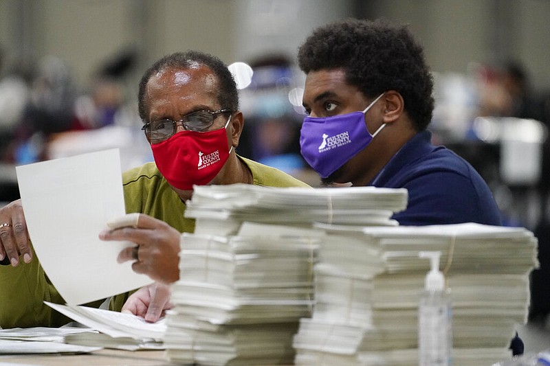 Officials sort ballots during an audit at the Georgia World Congress Center on Saturday, Nov. 14, 2020, in Atlanta. Election officials in Georgia's 159 counties undertook a hand tally of the presidential race stemming from an audit required by state law. story.lead_photo.caption
