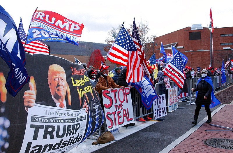 About 100 supporters of President Donald Trump stand in Williamsport, Pa., across West Third Street from the Federal Building, in this Tuesday, Nov. 17, 2020, file photo. Attorneys for the Trump campaign were inside the building, arguing that the state and seven county election boards should not certify the results of the general election because voters across the state were not treated the same. story.lead_photo.caption