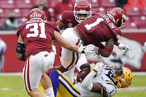 Arkansas defensive back Jalen Catalon (1) tackles LSU receiver Kayshon Boutte (1) during the second half of an NCAA college football game Saturday, Nov. 21, 2020, in Fayetteville, Ark. Catalon was called for targeting on the play and ejected from the game. (AP Photo/Michael Woods)