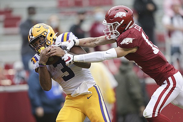 LSU running back Tyrion Davis-Price (3) attempts to catch a pass as Arkansas cornerback Hudson Clark defends during a game Saturday, Nov. 21, 2020, in Fayetteville.