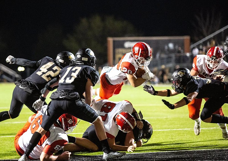 Cabot’s Jacob Parks (center) dives into the end zone for a touchdown during the third quarter against Bentonville during Friday night’s Class 7A playoff game in Bentonville. Article, Page 5C. More photos available at arkansasonline.com/1121cabotbville.
(Special to the NWA Democrat-Gazette/David Beach)