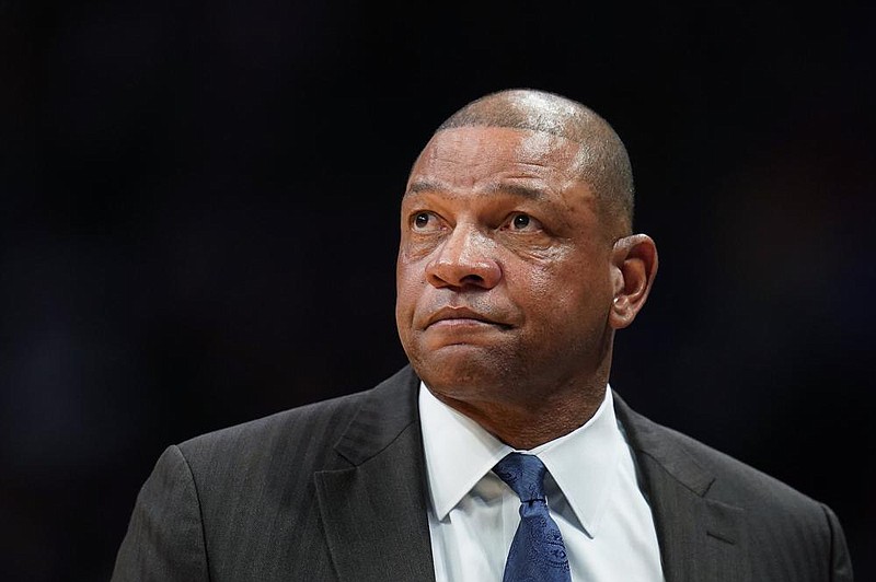 FILE - In this Jan. 12, 2020, file photo, former Los Angeles Clippers coach Doc Rivers watches during the second quarter of the team's NBA basketball game against the Denver Nuggets in Denver. The Philadelphia 76ers have reached an agreement with Rivers to become their new coach. Rivers reached a deal Thursday to become the latest coach to try to lead the Sixers to their first NBA championship since 1983, a person with direct knowledge of the negotiations told The Associated Press. The person spoke to the AP on Thursday on condition of anonymity because the Sixers had not formally announced the move. (AP Photo/Jack Dempsey, File)