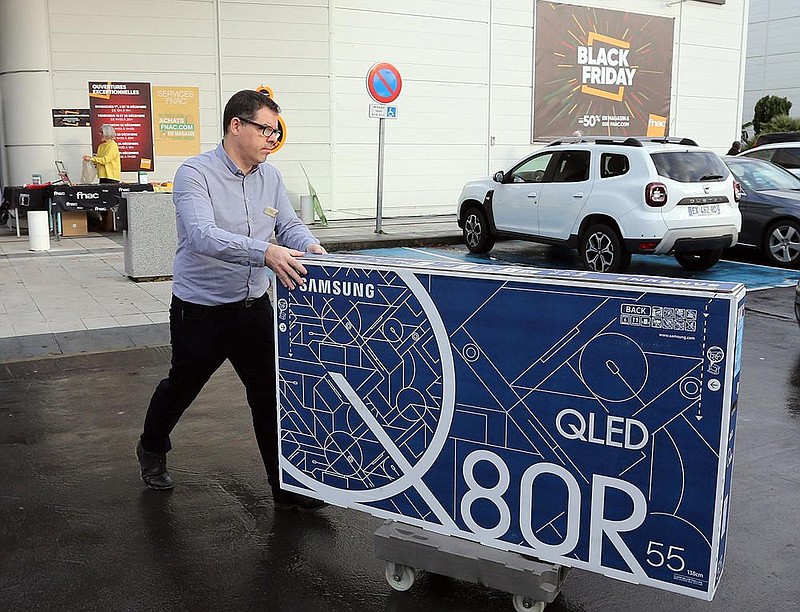 A man leaves a store with a flat screen on Black Friday in 2019 in Bayonne, southwestern France. The French government has postponed Black Friday this year.
(AP)