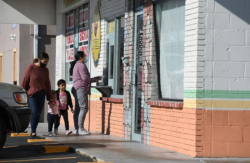 Customers buy tortillas at a walk-up window Thursday at Morelia Mexican Restaurant & Tortilleria in Springdale.
(NWA Democrat-Gazette/J.T. Wampler)