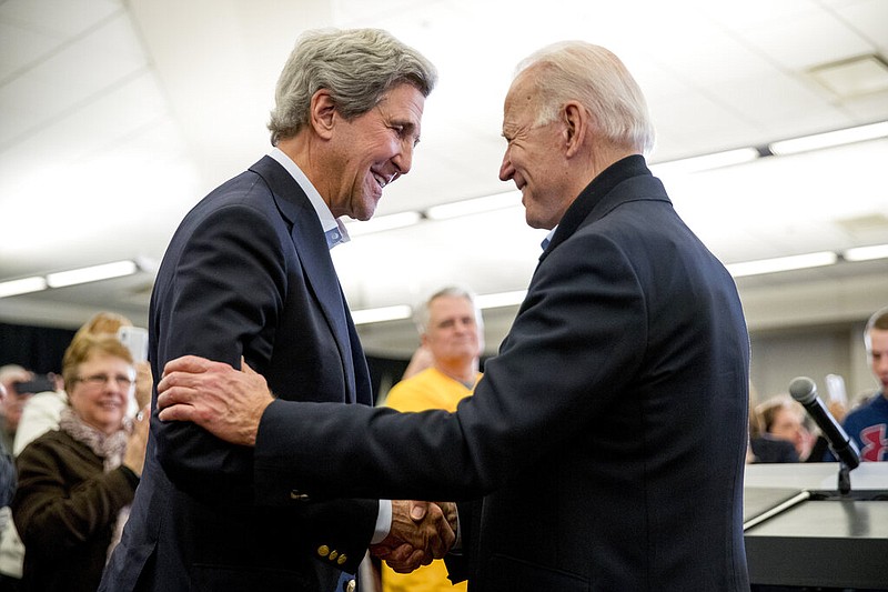 FILE - In this Feb. 1, 2020, file photo Democratic presidential candidate former Vice President Joe Biden smiles as former Secretary of State John Kerry, left, takes the podium to speak at a campaign stop at the South Slope Community Center in North Liberty, Iowa. (AP Photo/Andrew Harnik, File)


