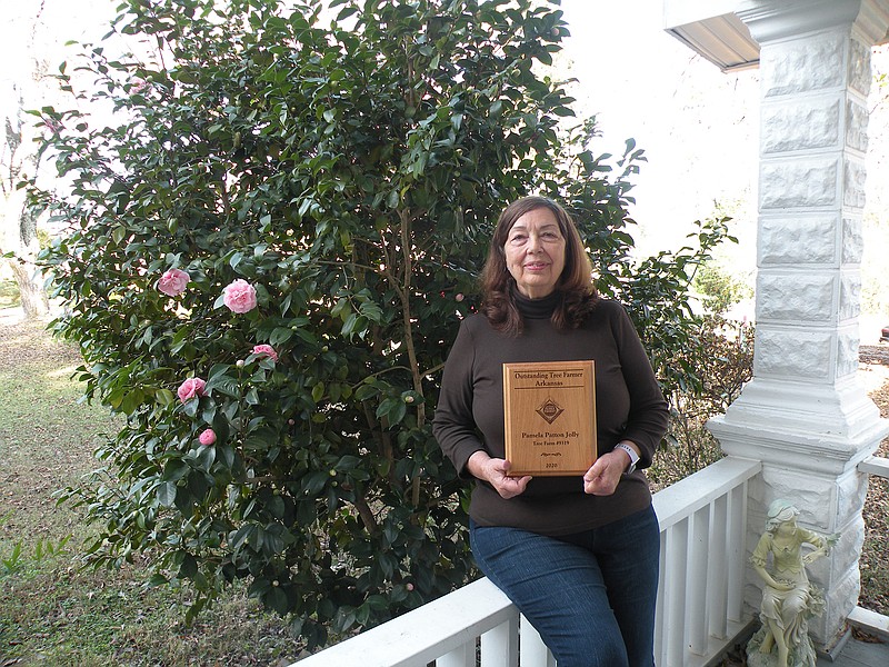Pamela Patton Jolly of Wooster is the 2020 Arkansas Outstanding Tree Farmer. She is shown here at her home in Wooster with the plaque she received from the Arkansas Tree Farm Program, which is administered by the Arkansas Forestry Association. Jolly’s 223-acre farm is in Yell County near Danville.