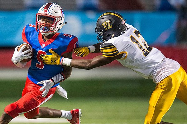 Watson Chapel defensive back Damarione Woodson (12) tries to tackle Little Rock Parkview's Demetrius Feemster (9) during a game Thursday, Oct. 10, 2019, at War Memorial Stadium in Little Rock.