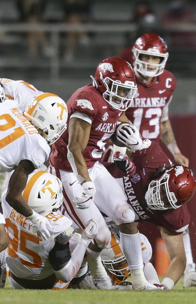 Senior tailback and team captain Rakeem Boyd (center) was among a group of key Razorback players who did not compete Saturday in the Razorbacks’ 27-24 loss to LSU. Continued coronavirus issues in the Arkansas program have led to the postponement of this week’s game against Missouri. (NWA Democrat-Gazette/Charlie Kaijo) 