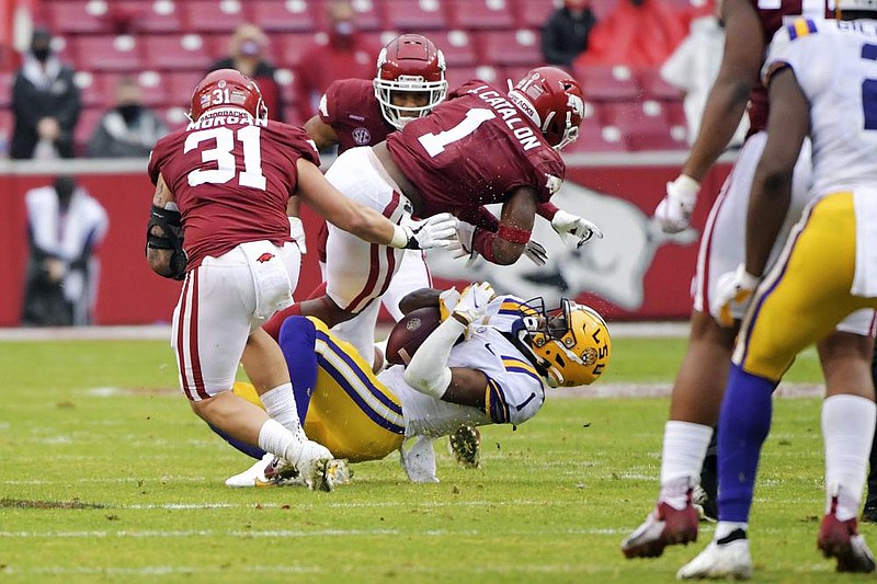 Arkansas defensive back Jalen Catalon (1) tackles LSU receiver Kayshon Boutte (1) during the second half of an NCAA college football game Saturday, Nov. 21, 2020, in Fayetteville, Ark. Catalon was called for targeting on the play and ejected from the game. (AP Photo/Michael Woods)