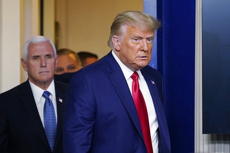 President Donald Trump walks out to speak in the Brady Briefing Room in the White House, Tuesday, Nov. 24, 2020, in Washington, with Vice President Mike Pence. (AP Photo/Susan Walsh)

