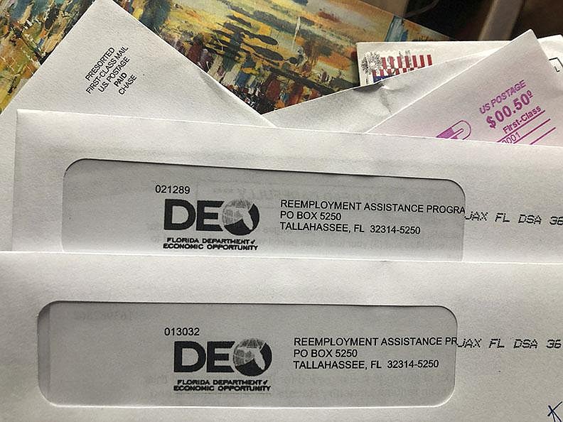 Florida unemployment aid letters await recipients earlier this month in Surfside, Fla. Nationally, unemployment filings are up by more than 100,000 from the first week of November.
(AP/Wilfredo Lee)