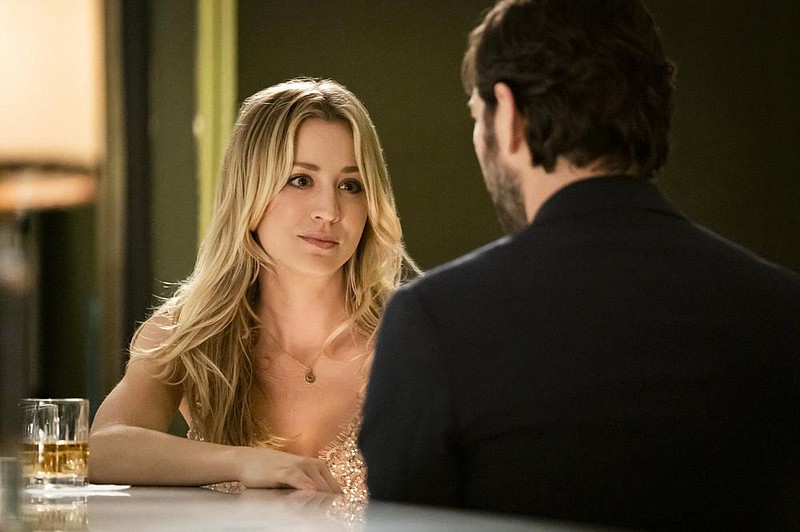 This image released by HBO Max shows Kaley Cuoco, left, and Michiel Huisman in a scene from "The Flight Attendant." The eight-episode series debuts on HBO Max on Nov. 26.
 (Phil Caruso/HBO Max via AP)