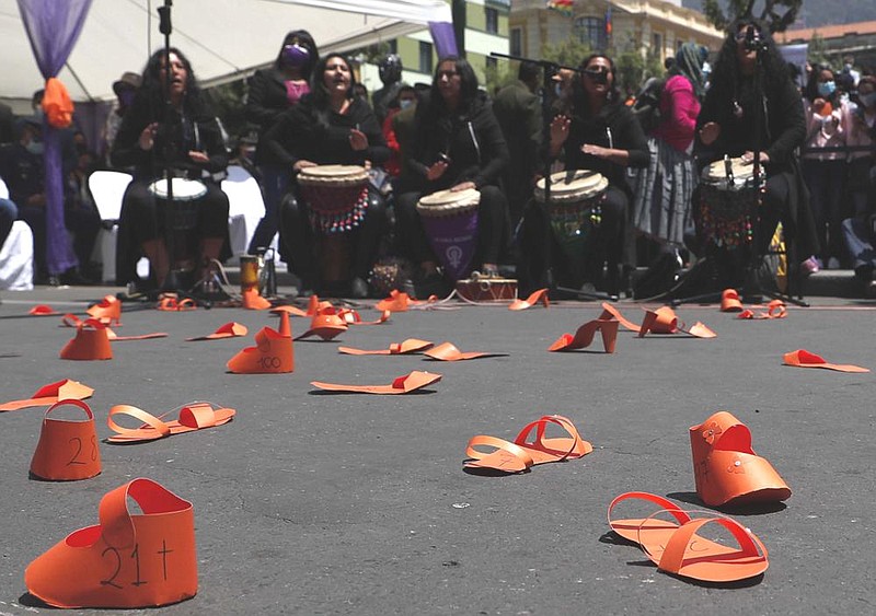Orange-colored paper shoes representing victims of violence are displayed on a road Wednesday in La Paz, Bolivia, during a demonstration marking the International Day for the Elimination of Violence against Women.
(AP/Juan Karita)