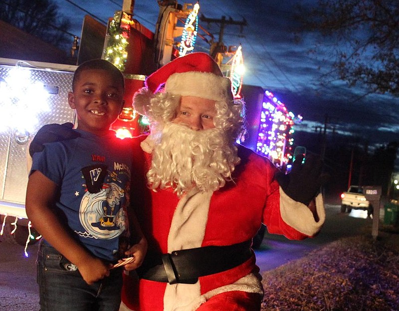 Six-year-old Nolan Parks of Pine Bluff gets a visit from Santa (Pine Bluff firefighter Austin Harris) during last year’s Holiday Santa Run when the Santa Fire Truck came to his Faucett Road neighborhood. The Holiday Santa Run will be held nightly Nov. 30 through Dec. 24 in various areas throughout the city. Due to covid-19 restrictions, this year, social distancing will be enforced and masks are required. 
(File photo)