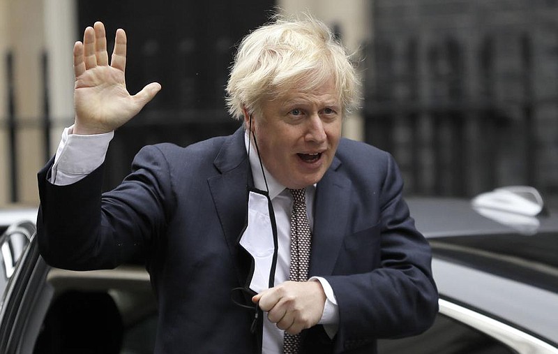 British Prime Minister Boris Johnson said Thursday that “tough measures” will be needed until spring, when a combination of vaccines and mass testing are forecast to help life return to normal. More photos at arkansasonline.com/1127england.
(AP/Kirsty Wigglesworth)