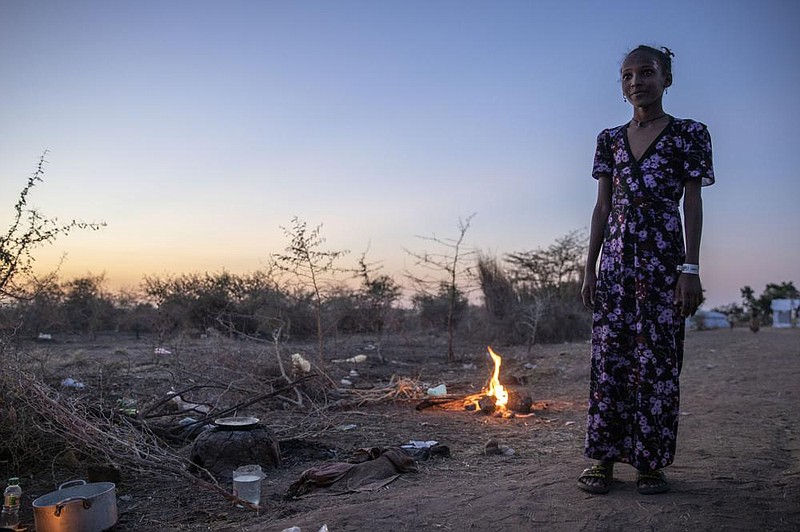 A Tigray girl who fled the conflict in Ethiopia’s Tigray region watches women cook in front of her shelter Wednesday at the Umm Rakouba refugee camp in Qadarif, eastern Sudan. More photos online at arkansasonline.com/1127ethopia
(AP/Nariman El-Mofty)