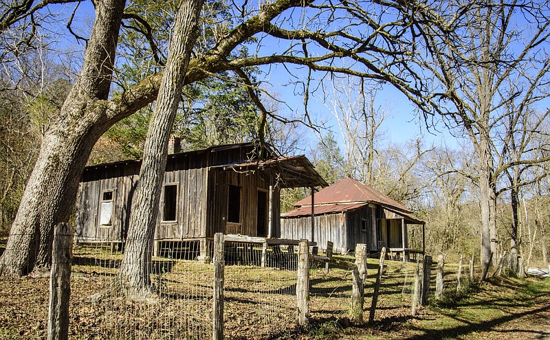 The Washhouse with the gabled roof (left) and the Bundy House with the hip roof were built about 1899 and have board and batten siding. According to the National Register of Historic Places Nomination form, the Washhouse was built in a rougher style while the Bundy house would have been “a fine dwelling in its day.” (Arkansas Democrat-Gazette/Cary Jenkins)