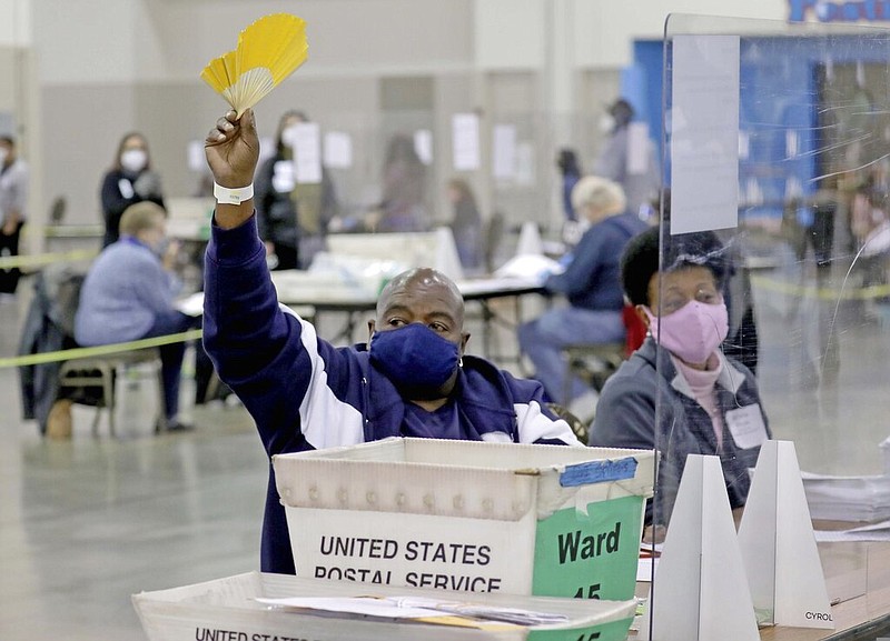 An election worker requests help while recounting ballots at the presidential election recount at Milwaukee's Wisconsin Center on Saturday, Nov. 21, 2020.