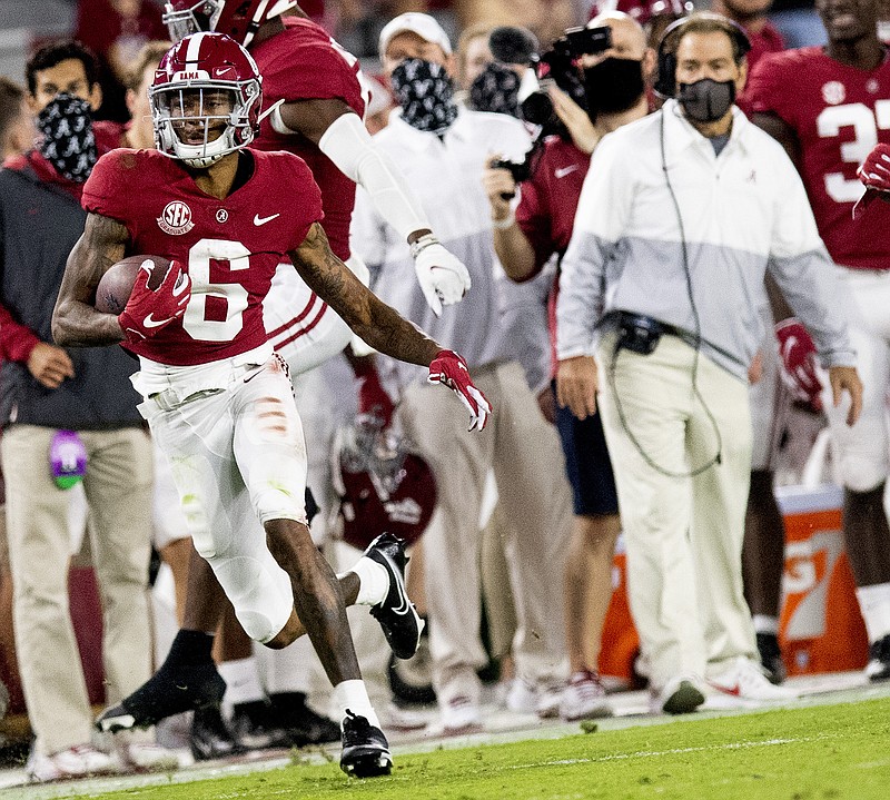 Alabama wide receiver DeVonta Smith (6) heads for a long gain as coach Nick Saban watches during the team's NCAA college football game against Kentucky on Saturday, Nov. 21, 2020, in Tuscaloosa, Ala. 