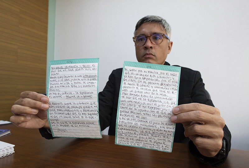 Jesus Loreto, an attorney representing Tomeu Vadell, one of six U.S. oil executives jailed in Venezuela, earlier this week in Caracas shows a letter written by Vadell in which Vadell pleads for his freedom.
(AP/Ariana Cubillos)