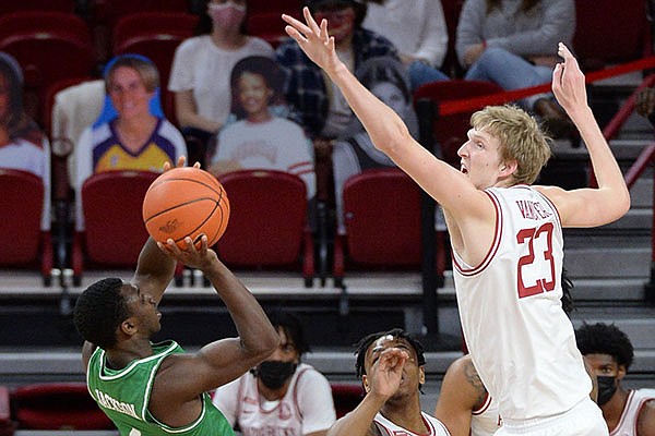 Arkansas' Connor Vanover (23) attempts to block a shot by North Texas' Jalen Jackson during a game Saturday, Nov. 28, 2020, in Fayetteville. 