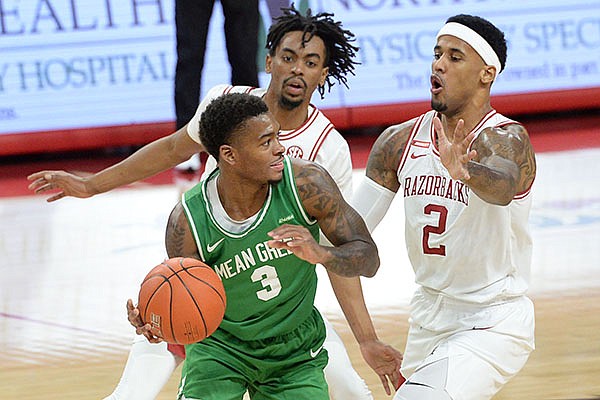 North Texas' Javion Hamlet (3) is double teamed by Arkansas' Vance Jackson (2) and Jalen Tate during a game Saturday, Nov. 28, 2020, in Fayetteville. 