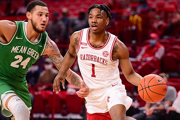 Arkansas' JD Notae (1) drives around North Texas' Zachary Simmons (24) during a game Saturday, Nov. 28, 2020, in Fayetteville. 