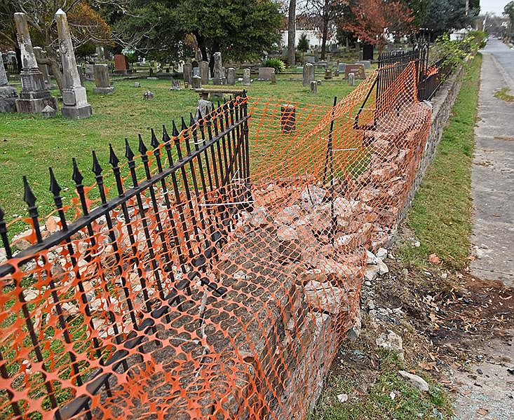 A safety fence lines a damaged section at the historic Mount Holly Cemetery in Little Rock.
(Arkansas Democrat-Gazette/Staci Vandagriff)