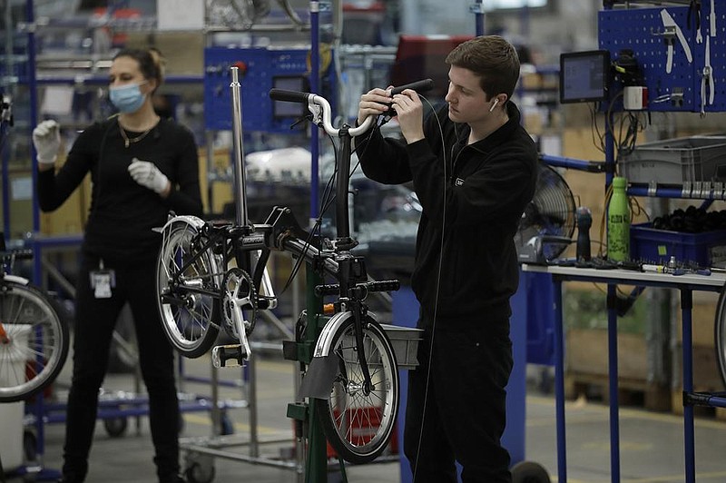 Brompton folding bicycles are assembled by hand earlier this week at the Brompton factory in London.
(AP/Matt Dunham)