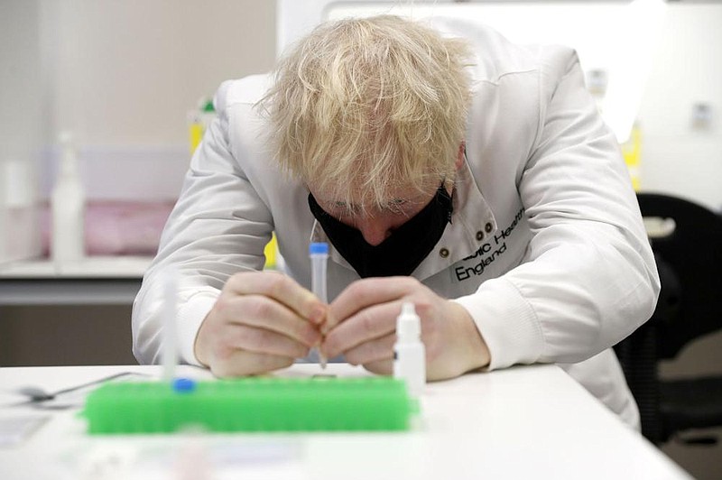 British Prime Minister Boris Johnson gets a close look at a sample at the Lateral Flow Testing Laboratory during a visit Friday to the Public Health England site at Porton Down science park near Salisbury in southern England. Johnson spoke to scientists working on coronavirus testing methods.
(AP/Adrian Dennis)