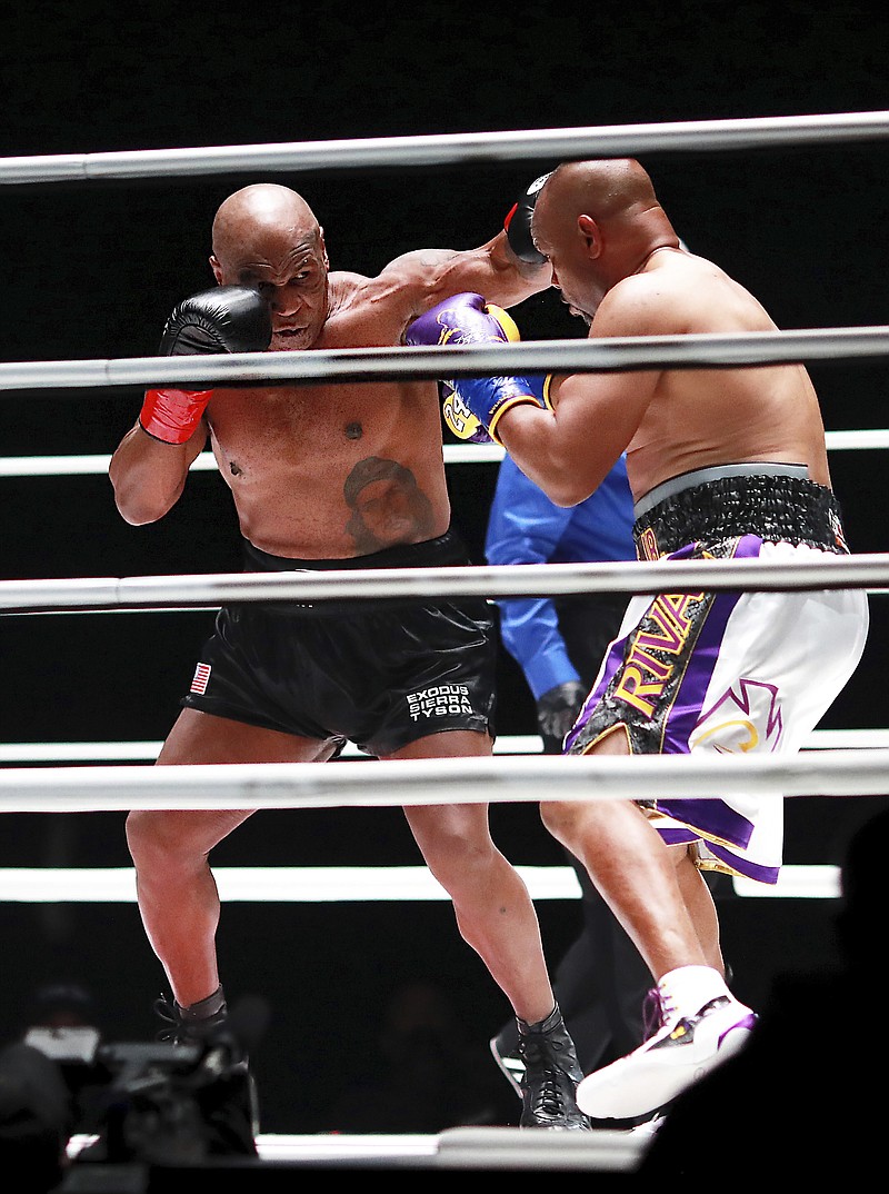 In a photo provided by Triller, Mike Tyson throws a punch during the third round against Roy Jones Jr. in an exhibition boxing bout Saturday in Los Angeles. The bout was unofficially ruled a draw by the WBC judges at ringside. Tyson and Jones fought eight two-minute rounds, and both emerged smiling and apparently healthy from a highly unusual event. - Photo by Joe Scarnici/Triller via The Associated Press