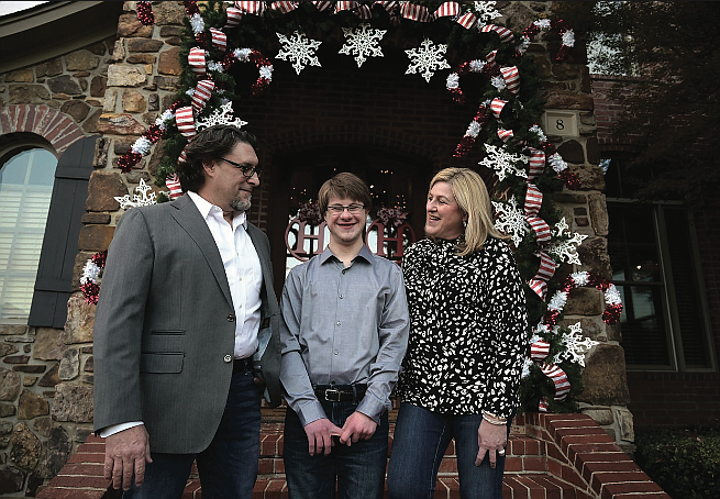 Dr. James Hunt (left), his son, Al, and his wife, DeAnn, seen outside their home earlier this month in Little Rock. (Arkansas Democrat-Gazette/Stephen Swofford)