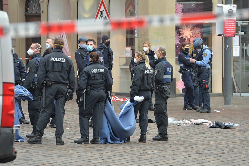 A street is blocked by the police in Trier, Germany, Tuesday, Dec. 1, 2020. German police say people have been killed and several others injured in the southwestern German city of Trier when a car drove into a pedestrian zone. Trier police tweeted that the driver had been arrested and the vehicle impounded. (Harald Tittel/dpa via AP)