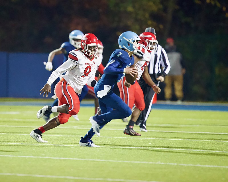 Magnolia senior Javorrea Murphy chases Pulaski Academy’s Charlie Fiser during high school playoff action Friday night. The Panthers fell 53-29, ending their season with an 8-3 overall record.