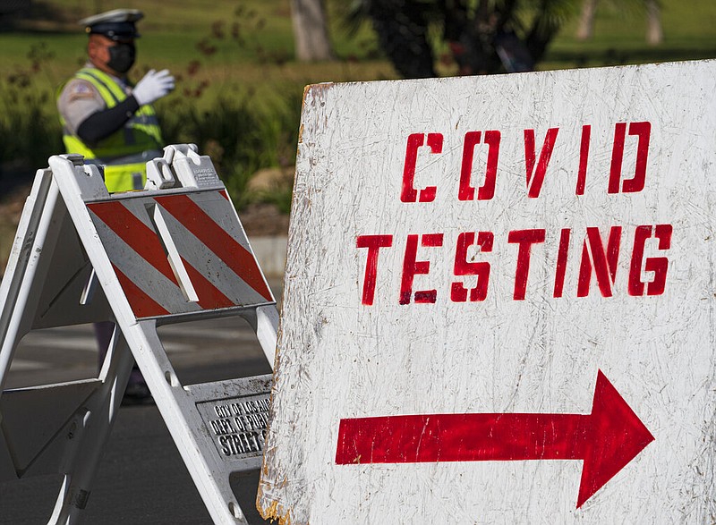 A covid testing sign directs drivers waiting in line to get a free covid-19 self-test at Dodger Stadium in Los Angeles, Tuesday, Dec. 1, 2020. (AP Photo/Damian Dovarganes)


