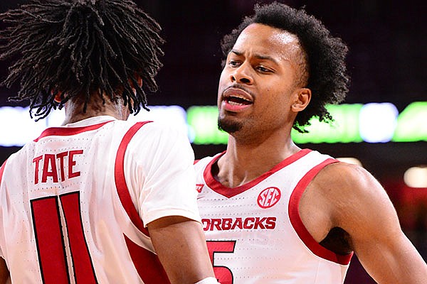 Arkansas' Moses Moody (5) celebrates with teammate Jalen Tate (11) during a game against Texas-Arlington on Wednesday, Dec. 2, 2020, in Fayetteville.