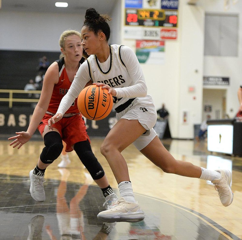 Bentonville's Jada Brown (right) drives to the lane Tuesday, Dec. 1, 2020, as Farmington's Carson Dillard defends during the first half of play in Tiger Arena in Bentonville. Visit nwaonline.com/201202Daily/ for today's photo gallery. 
(NWA Democrat-Gazette/Andy Shupe)