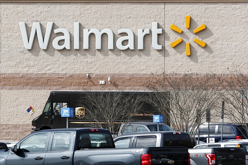 This March 17, 2020 photo shows a Walmart store in Mebane, N.C. Walmart says for the fourth time during the pandemic it will give its 1.5 million U.S. part-time and full-time employees additional cash bonuses for their work.