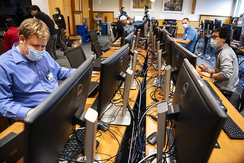 In this photo provided by the University of Vermont Health Network, IT staff at the University of Vermont Medical Center in Burlington, Vt., continue work to scan thousands of the hospital's computer systems for malware on Friday, Nov. 20, 2020, after the Oct. 28 cyberattack forced a shut down of the hospital's electronic medical records system and other key systems. (Ryan Mercer/University of Vermont Health Network via AP)

