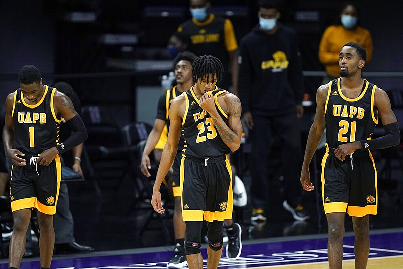 University of Arkansas at Pine Bluff players walk onto the court during the second half of the team's NCAA college basketball game against Northwestern in Evanston, Ill., on Wednesday, Dec. 2, 2020.