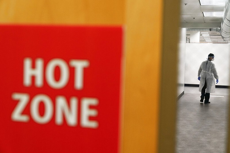 FILE - In this Dec. 1, 2020, file photo, a worker walks through the hallway of a newly opened field hospital operated by Care New England to handle a surge of covid-19 patients in Cranston, R.I. States faced a deadline on Friday, Dec. 4, 2020, to place orders for the coronavirus vaccine as many reported record infections, hospitalizations and deaths, while hospitals were pushed to the breaking point — with the worst feared yet to come. (AP Photo/David Goldman, File)
story.lead_photo.caption