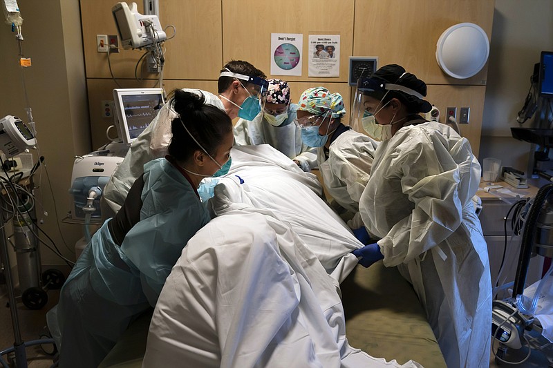 In this Nov. 19, 2020, file photo, medical personnel prone a COVID-19 patient at Providence Holy Cross Medical Center in the Mission Hills section of Los Angeles. Across the U.S., the surge has swamped hospitals with patients and left nurses and other health care workers shorthanded and burned out.