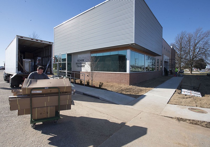 Jon Brooks unloads new furniture Monday at Ozark Regional Transit’s new administration and operation center at 2423 E. Robinson Ave. in Springdale. Brooks works for NEO Cabinet in Springdale. Go to nwaonline.com/201204Daily/ and nwadg.com/photos for a photo gallery. (NWA Democrat-Gazette/J.T. Wampler)