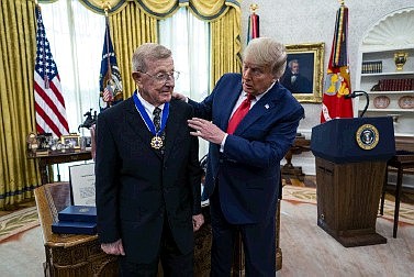 Former football coach Lou Holtz smiles after receiving the Presidential Medal of Freedom from President Donald Trump, in the Oval Office of the White House, Thursday in Washington.