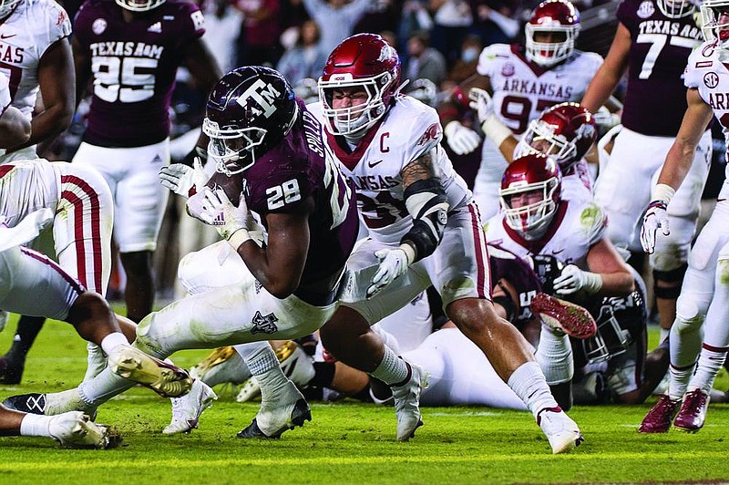 Linebackers Grant Morgan (left) of Arkansas and Nick Bolton (top) of Missouri are both defensive captains who play with attitude and are expected to be always around the ball Saturday as their teams face off at Faurot Field in Columbia, Mo.
(AP file photos)