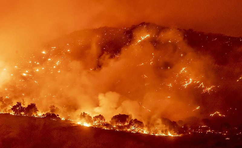 Wildfire flames race across Southern California hillsides early Thursday west of Santiago Canyon Road near Silverado Canyon.
(AP/The Orange County Register/Leonard Ortiz)