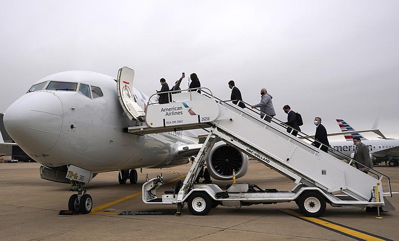 Passengers board an American Airlines Boeing 737 Max jet before departing from Dallas Fort Worth airport in Grapevine, Texas, on Wednesday as the airline prepares to return the Max jets to service.
(AP/LM Otero)