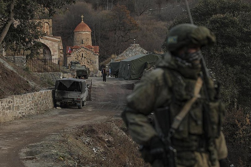 A Russian peacekeeper guards an entrance of the Dadivank, an  Armenian Apostolic Church monastery dating to the 9th century, Wednesday after  transfer of the Kalbajar region to Azerbaijan’s control, as part of a peace deal.
(AP/Emrah Gurel)